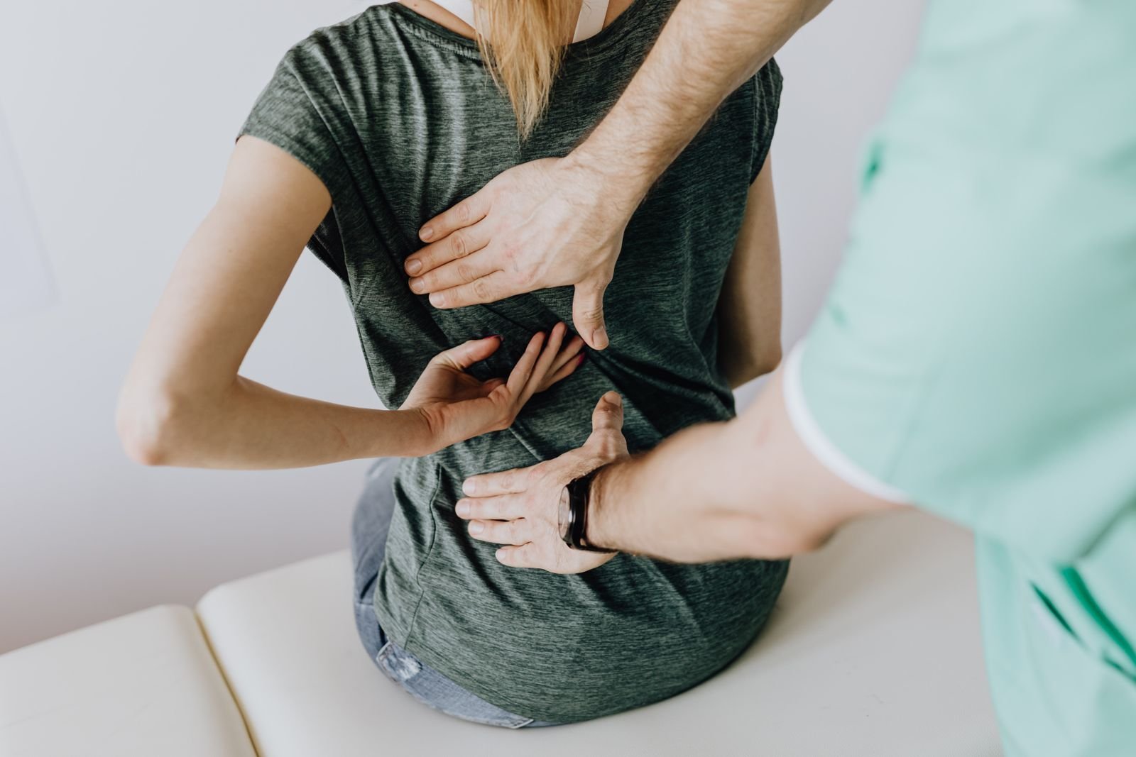 A chiropractor examining a patient's back
