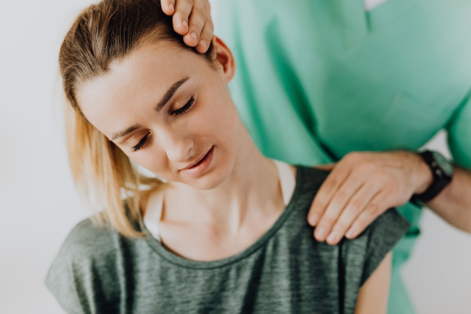 A chiropractor performing a neck adjustment